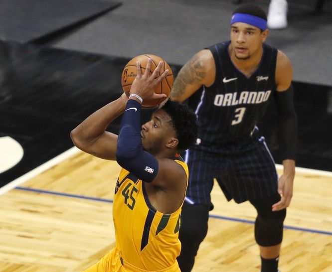 Utah Jazz guard Donovan Mitchell (45) drives to the basket past Orlando Magic forward Chuma Okeke (3) in the first quarter during an NBA basketball game, Saturday, Feb. 27, 2021, in Orlando, Fla. (AP Photo/Joe Skipper)