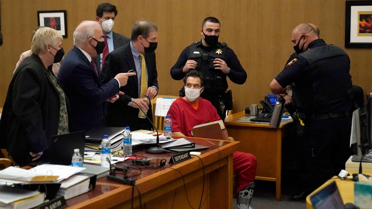 Scott Peterson, seated at right, listens as attorney Pat Harris, standing, speaks during a hearing at the San Mateo County Superior Court in Redwood City, Calif., on Monday. (AP Photo/Jeff Chiu, Pool)