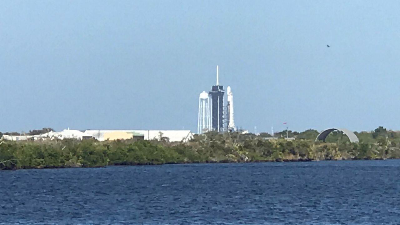 A Falcon 9 rocket sits at Kennedy Space Center's Pad 39A on Sunday afternoon. The launch countdown was stopped with just more than a minute remaining, and SpaceX says it will try again Tuesday night. (Greg Pallone/Spectrum News)