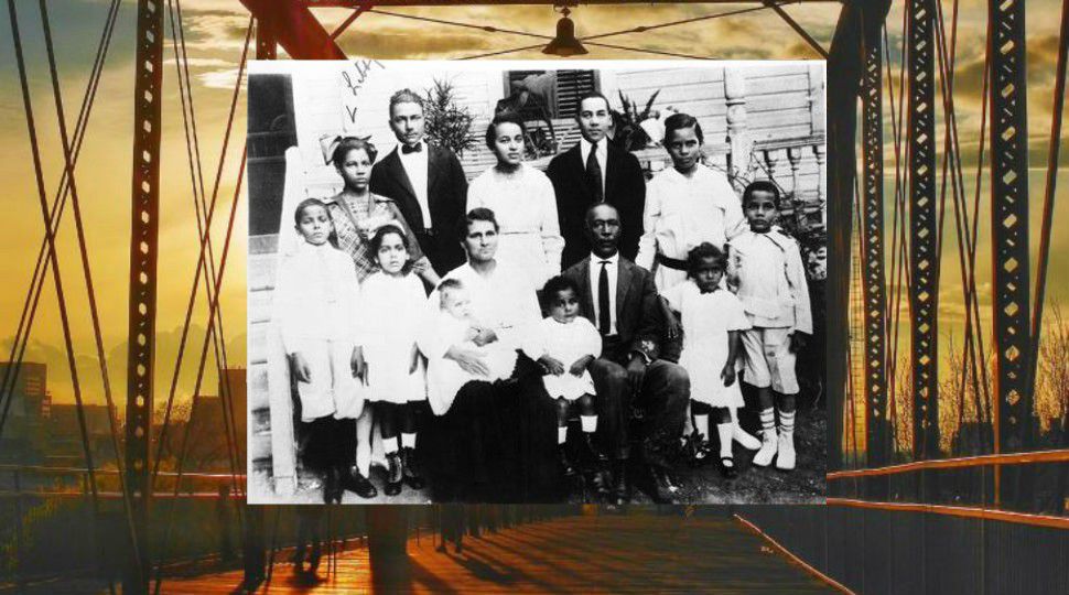 Samuel J. Sutton Family outside their home in 1917, 430 N. Cherry Street, San Antonio, Texas (Photograph shows Samuel J. and Lillian V. Sutton and their children. (L. to r.) front row: Garlington Jerome "G.J." or "Dee" Cora Mary "Janey", Essie in the arms of her mother, Oliver C.Snooks" Smithie D. "Honey" and William N. "Bill;" back row: Libby Louise, John Westly, Carrie Jane, Sam Jr., and Lillian.) (Courtesy: UTSA Libraries Digital Collection)