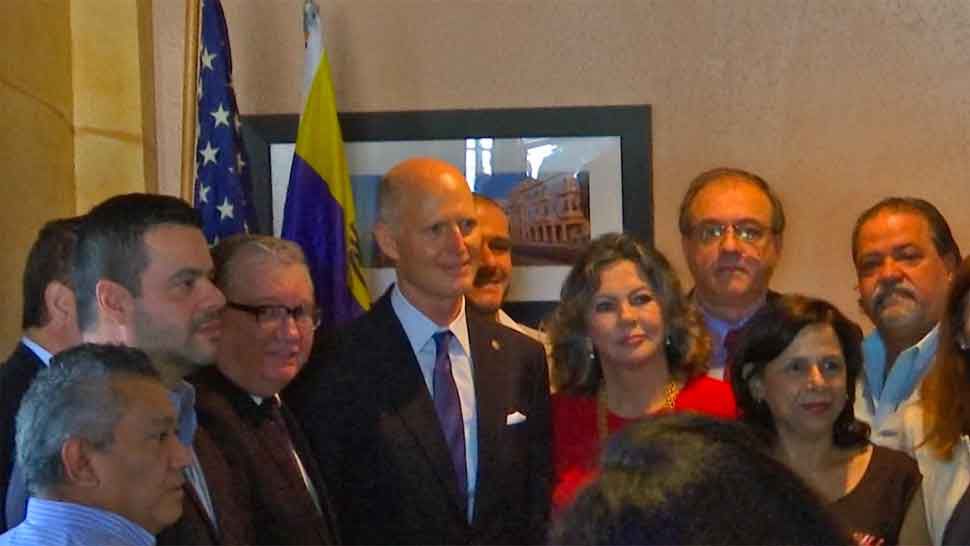 Sen. Rick Scott takes a photo with members of Casa Venezuela Tampa Bay, Monday, February 11, 2019. (Adria Iraheta/Spectrum Bay News 9)