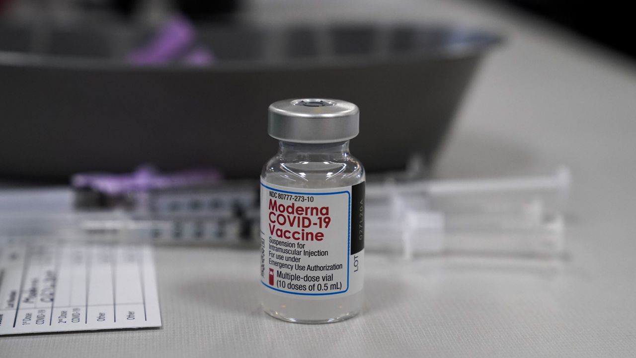 A vile of Moderna COVID-19 vaccine is seen at an ambulance company in Santa Fe Springs, Calif., Saturday, Jan. 9, 2021. (AP Photo/Jae C. Hong)