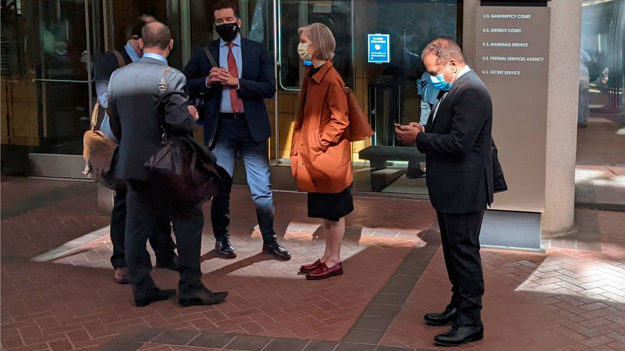 Former Theranos executive Ramesh "Sunny" Balwani, right, stands near his legal team outside Robert F. Peckham U.S. Courthouse in San Jose, Calif., on March 1, 2022. (AP Photo/Michael Liedtke, File)