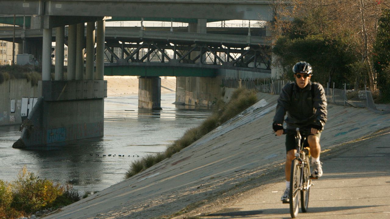In this Jan.21,2007 file photo showing a bicyclist riding along a path running along the cement-lined Los Angeles River in Los Angeles. (AP Photo/Ric Francis)