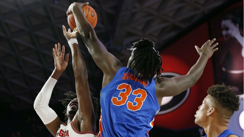 Florida center Jason Jitoboh (33) blocks a shot from Georgia's Rayshaun Hammonds (20) during the first half of an NCAA college basketball game Wednesday, March 4, 2020, in Athens, Ga. (Joshua L. Jones/Athens Banner-Herald via AP)