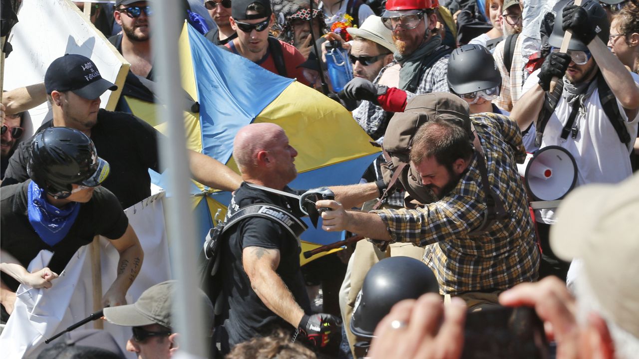 White nationalist demonstrators clash with counter demonstrators at the entrance to Lee Park in Charlottesville, Va. on Aug. 12, 2017. (AP Photo/Steve Helber)