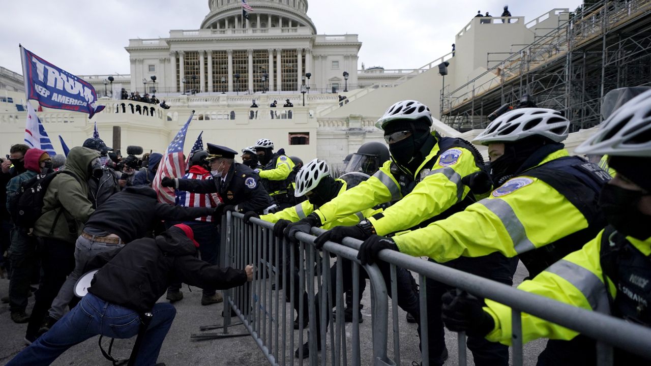 President Donald Trump supporters try to break through a police barrier, Wednesday, Jan. 6, 2021, at the Capitol in Washington. (AP Photo/Julio Cortez)