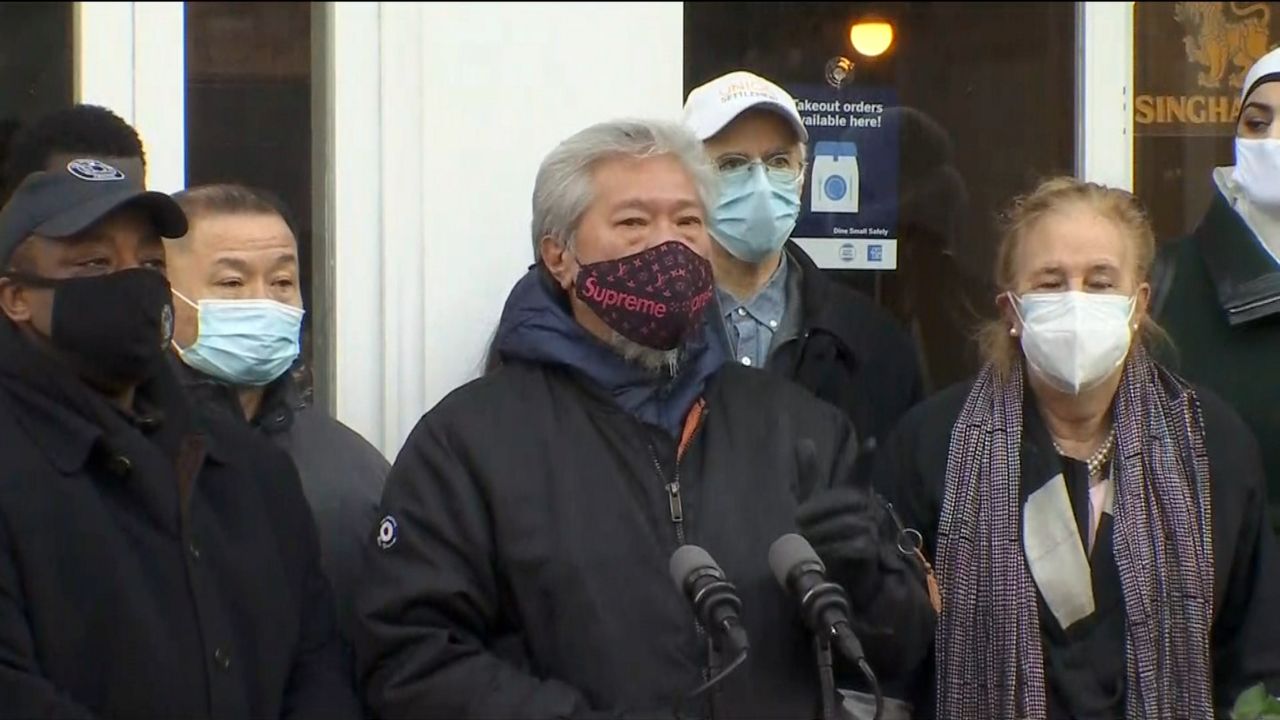 A group of people rally in East Harlem