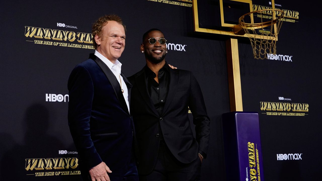 John C. Reilly, left, and Quincy Isaiah, cast members in "Winning Time: The Rise of the Lakers Dynasty," pose together at the premiere of the television series Wednesday at The Theatre at Ace Hotel in Los Angeles. (AP Photo/Chris Pizzello)