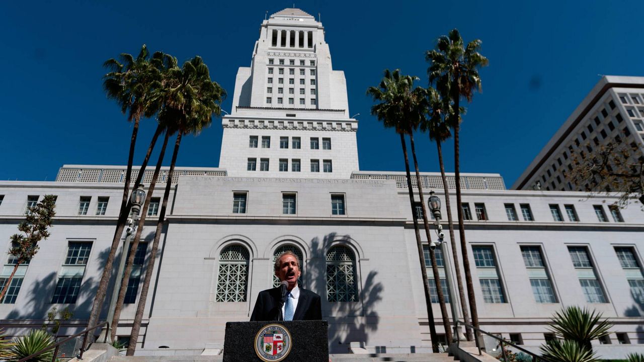 Los Angeles City Attorney Mike Feuer announces a lawsuit at a news conference outside Los Angeles City Hall on Monday. (AP Photo/Damian Dovarganes)