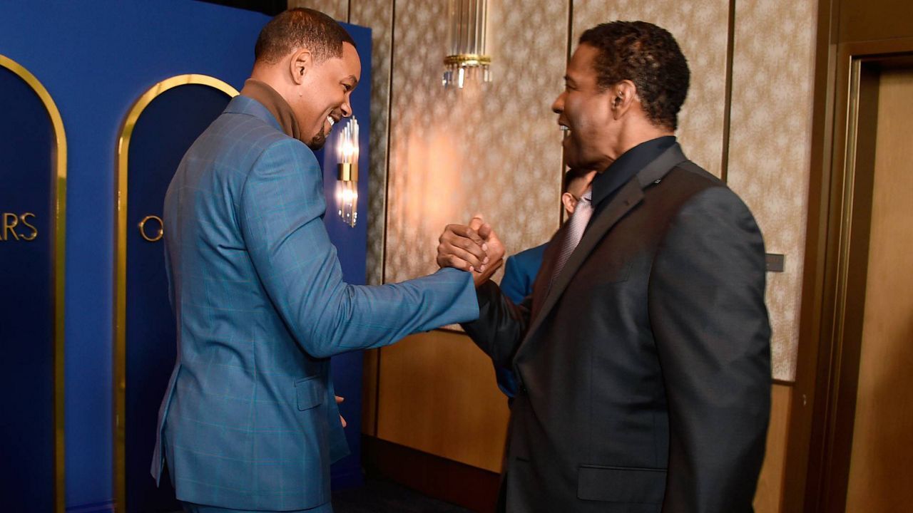 Will Smith, left, and Denzel Washington arrive at the 94th Academy Awards nominees luncheon on Monday in Los Angeles. (Photo by Jordan Strauss/Invision/AP)