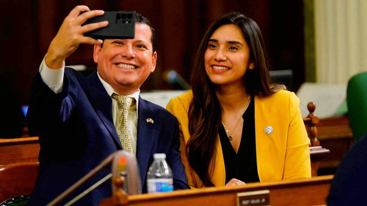 Democratic Assembly members Rudy Salas Jr., of Bakersfield, and Sabrina Cervantes, of Riverside, pose for a selfie at the Capitol in Sacramento, Calif., March 7, 2022. Salas Jr. is hoping to win a seat in Congress. (AP Photo/Rich Pedroncelli)