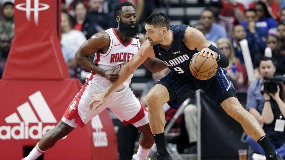 Orlando Magic center Nikola Vucevic (9) attempts to drive around Houston Rockets guard James Harden, left, during the first half of an NBA basketball game Sunday, March 8, 2020, in Houston. (AP Photo/Michael Wyke)