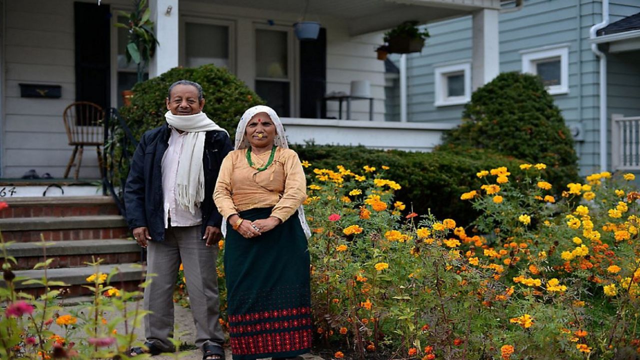 Photo of Bhutanese couple outside thier home in North Akron  