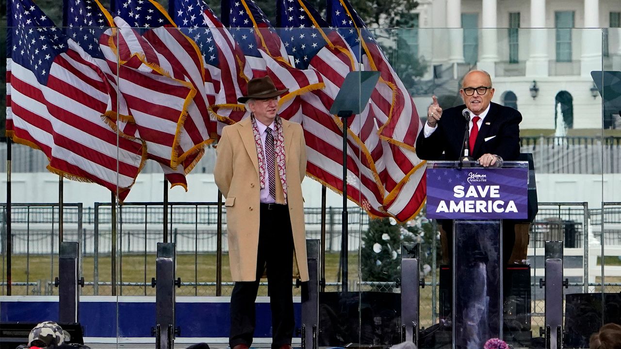 In this Jan. 6, 2021 file photo, Chapman University law professor John Eastman stands at left as former New York Mayor Rudolph Giuliani speaks in Washington at a rally in support of President Donald Trump, called the "Save America Rally." (AP Photo/Jacquelyn Martin, File)