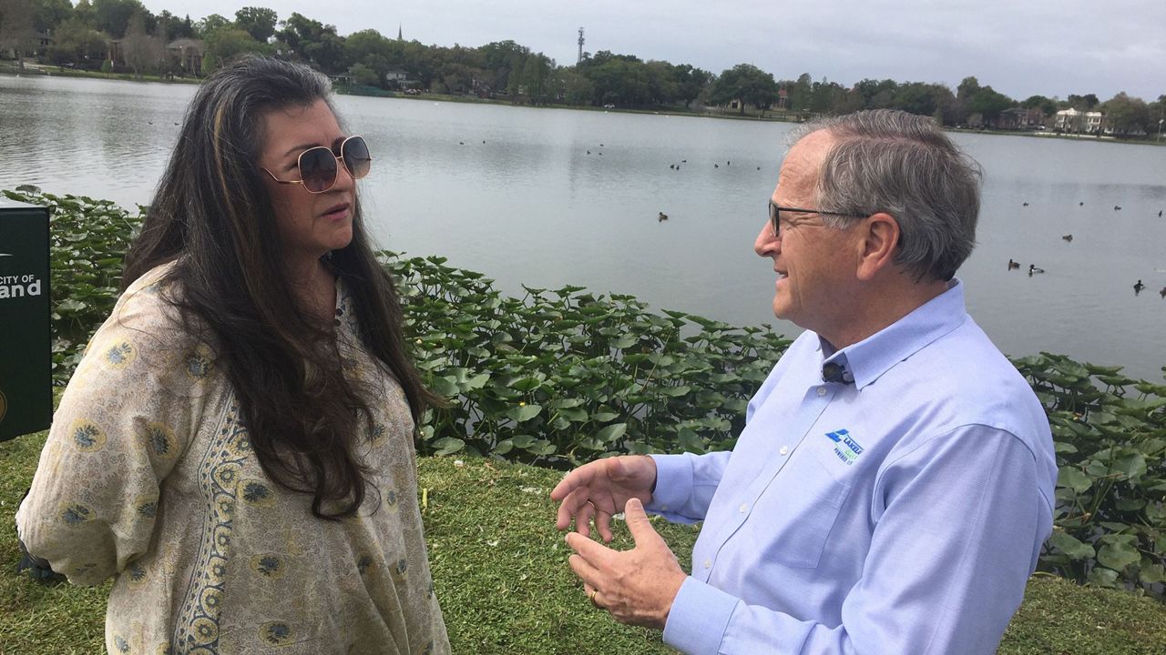 Resident Cynthia Young-Jennings talks with Mayor Bill Mutz after three swans were killed by cars in the Lake Morton area in little more than a week. (Rick Elmhorst/Spectrum Bay News 9)
