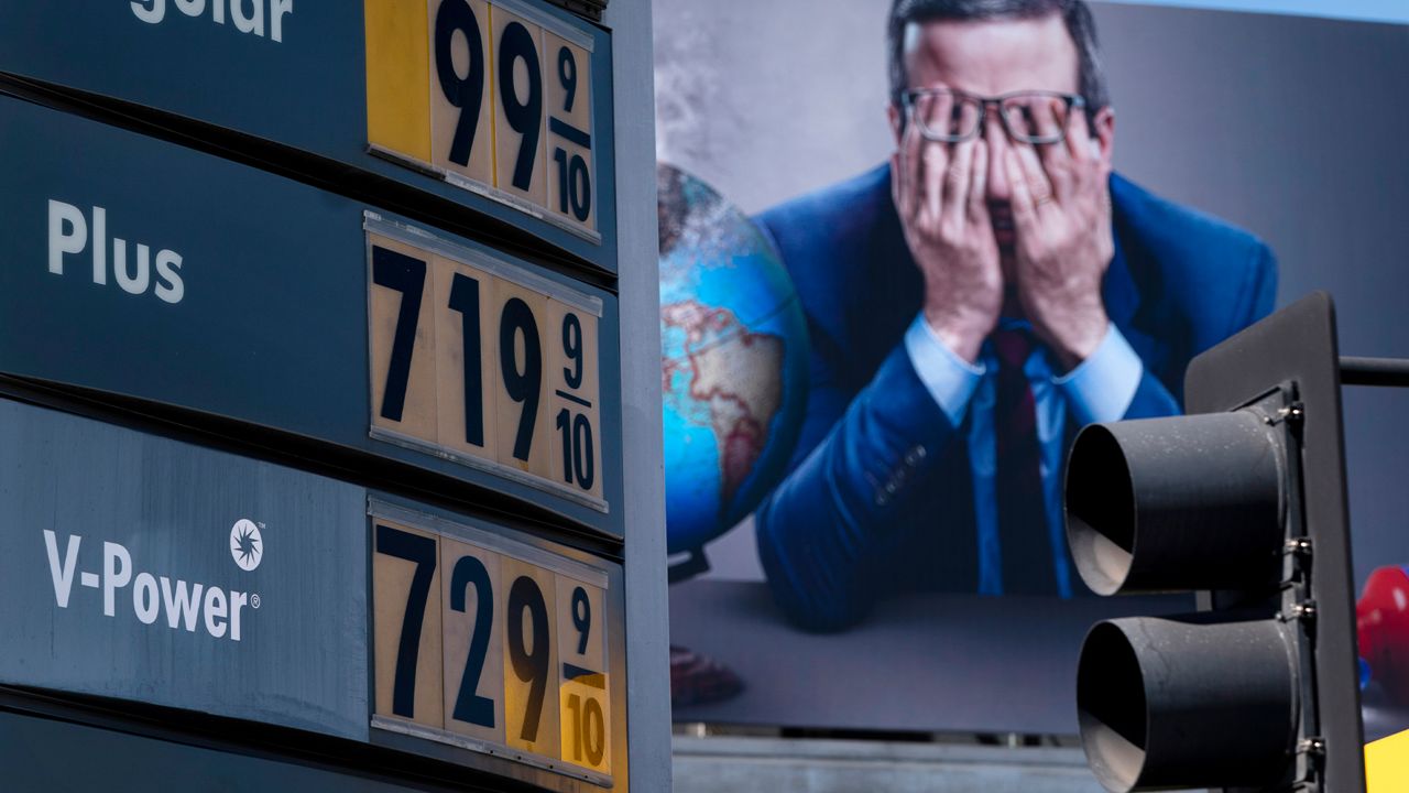 Gas prices are seen in front of a billboard advertising HBO's Last Week Tonight in Los Angeles, Monday, March 7, 2022. (AP Photo/Jae C. Hong)