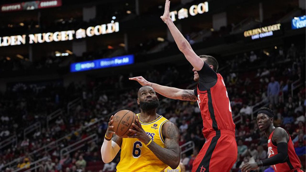 Los Angeles Lakers' LeBron James (6) goes up for a shot as Houston Rockets' Garrison Mathews defends during the first half of an NBA basketball game Wednesday, March 9, 2022, in Houston. (AP Photo/David J. Phillip)
