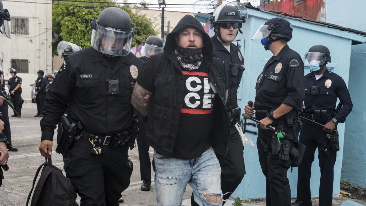 Police officers arrest a man during a protest over the death of George Floyd in Los Angeles, Saturday, May 30, 2020. (AP Photo/Ringo H.W. Chiu)