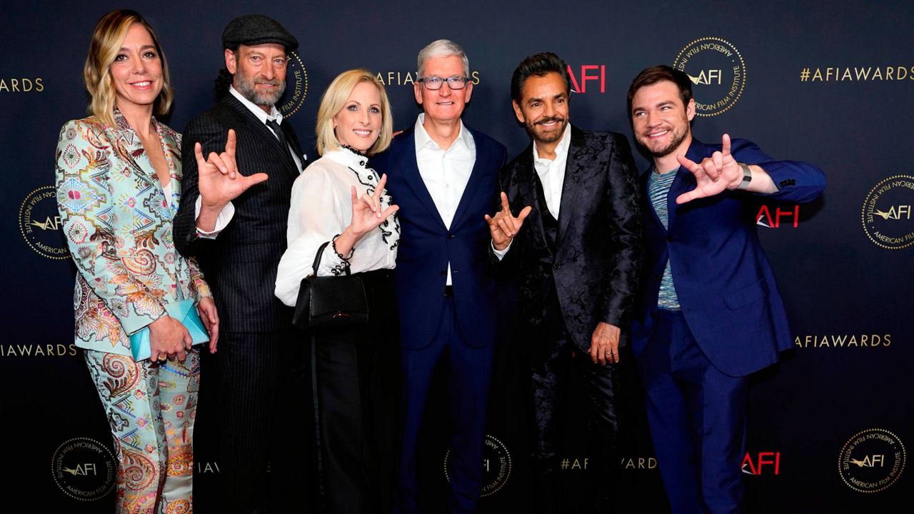 Sian Heder, from left, Troy Kotsur, Marlee Matlin, Apple CEO Tim Cook, Eugenio Derbez and Daniel Durant, from the film "CODA," arrive at the AFI Awards Luncheon on March 11, 2022, at the Beverly Wilshire Hotel. (AP Photo/Chris Pizzello)