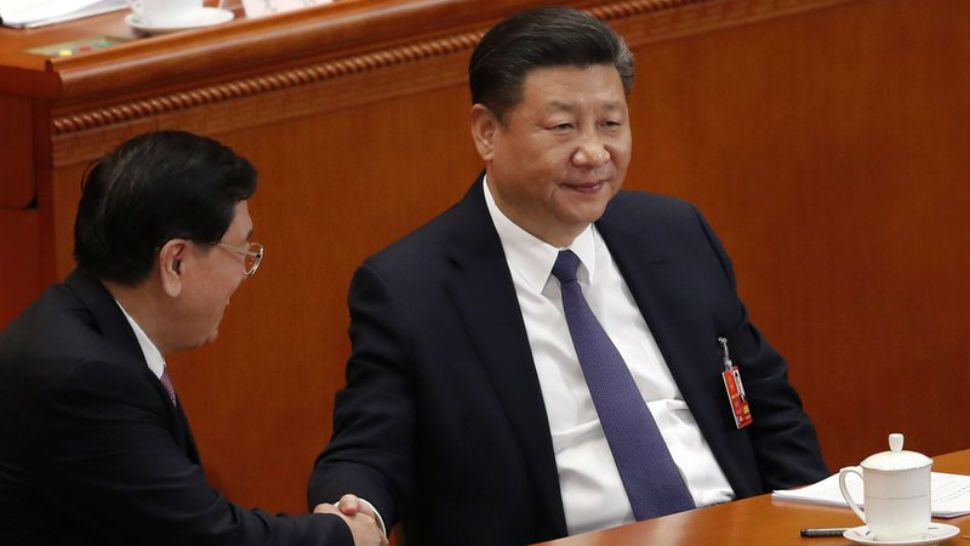 Chinese President Xi Jinping, right, shakes hands with National People’s Congress Chairman Zhang Dejiang during a plenary session of the National People’s Congress at the Great Hall of the People in Beijing, Sunday, March 11, 2018. China’s rubber-stamp lawmakers on Sunday passed a historic constitutional amendment abolishing presidential term limits that will enable Xi to rule indefinitely. (AP Photo/Andy Wong)
