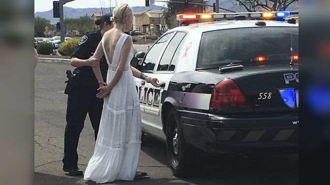 This photo provided by the Marana Police Department, in Arizona, shows 32-year-old Amber Young during her arrest on suspicion of impaired driving, Monday, March 12, 2018, in southern Arizona.  (Marana Police Department via AP)
