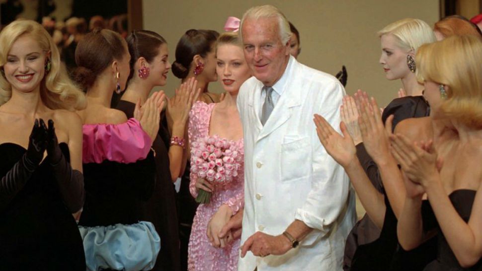 FILE - In this July 11 1995 file photo, French designer Hubert de Givenchy is applauded by his models after his 1995-96 fall-winter haute couture fashion collection in Paris. French couturier Hubert de Givenchy, a pioneer of ready-to-wear who designed Audrey Hepburn’s little black dress in “Breakfast at Tiffany’s,” has died at the age of 91. (AP Photo/Lionel Cironneau)