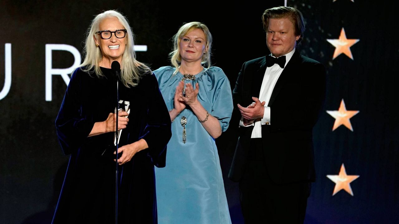 Jane Campion, from left, Kristen Dunst, and Jesse Plemons accept the award for best film for "The Power of the Dog" at the 27th annual Critics Choice Awards on Sunday at the Fairmont Century Plaza Hotel in Los Angeles. (AP Photo/Chris Pizzello)