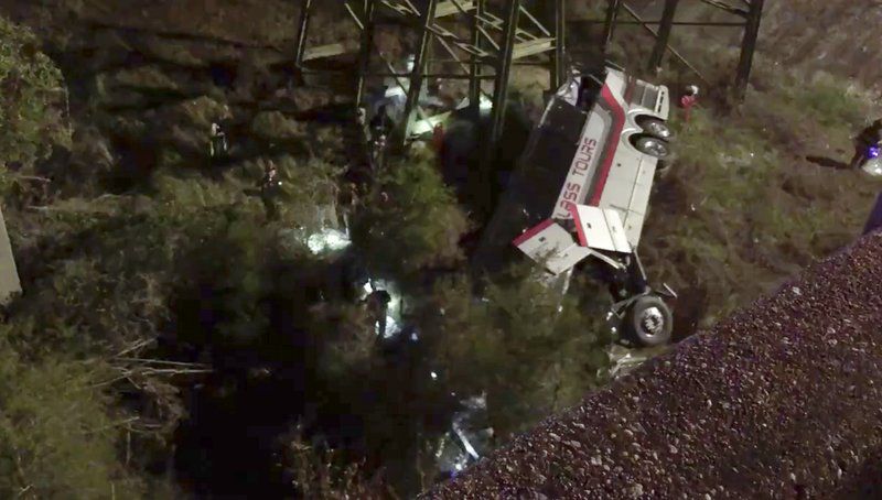 This photo provided by Jesus Tejada shows first responders searching around a bus that plunged into a ravine, Tuesday, March 13, 2018 on Interstate 10, Loxley, Ala. Several people were on board, and all of them were brought to 10 hospitals in Alabama and Florida, either by helicopter or ambulance, said Baldwin County Sheriff Huey Hoss Mack. (Jesus Tejada via AP)