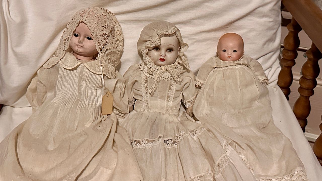 The three dolls are in the nursery — the one on the left has a child attached to it, according to Jesse Lisk, the ghost hunter and tour guide. (Spectrum Bay News 9/Virginia Johnson)