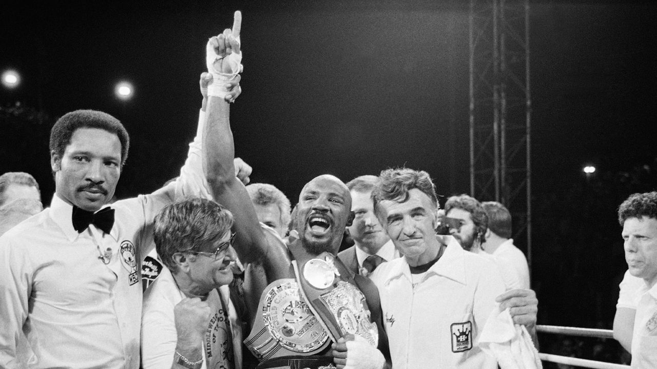 Middleweight Champion Marvelous Marvin Hagler celebrates his undisputed world middleweight Championship with his manager, Pat Petronelli, and Co-Manager, Goody Petronelli on Monday, April 15, 1985 in Las Vegas. Hagler knocked out Thomas "Hitman" Hearns in the third round to clinch the title. (AP Photo)