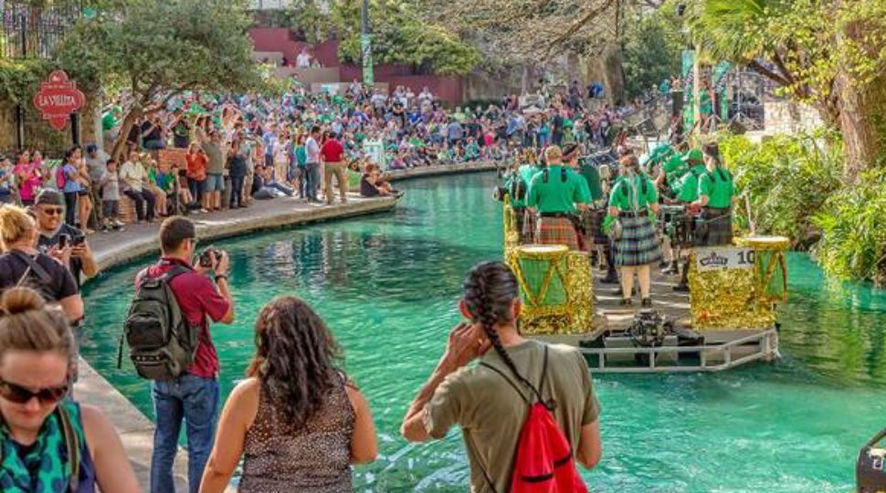 People line the River Walk for the St. Patrick's Day River Parade in 2018 (Courtesy: San Antonio River Walk Authority)