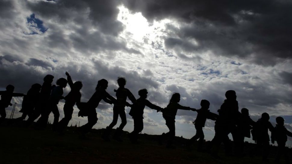 FILE - In this Dec. 3, 2016 file photo, Syrian children, who were displaced with their families from eastern Aleppo, play in the village of Jibreen south of Aleppo, Syria. In 2018, after seven years of war in Syria, the United Nations has one thing to say: Stop the war on children. Of Syria’s estimated 10 million children, 8.6 million are now in dire need of assistance, nearly 6 million children are displaced or living as refugees and about 2.5 million are out of school. (AP Photo/Hassan Ammar, File)
