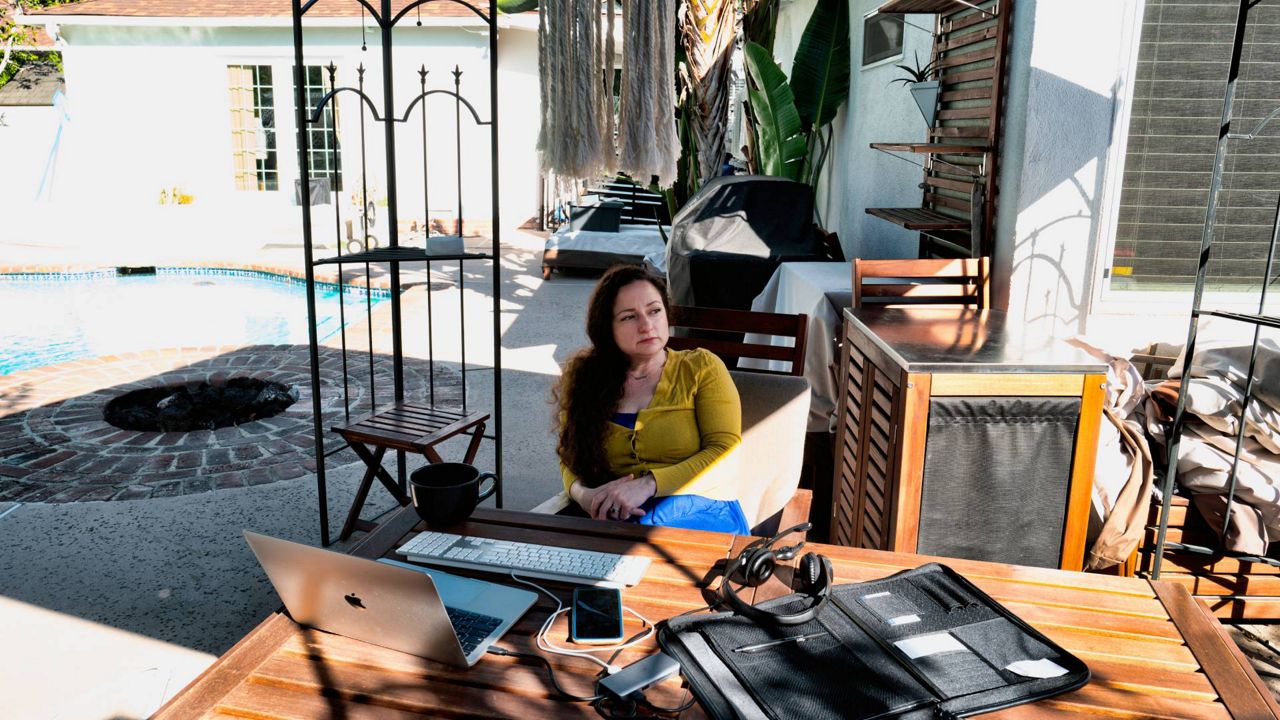 Julia Entin sits at her computer and ponders the fate of Jewish Holocaust survivors in her backyard, coordinating efforts to rescue them in Ukraine Monday in Los Angeles. (AP Photo/Richard Vogel)