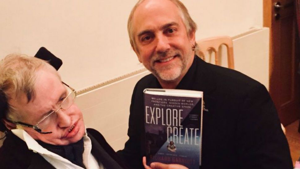 FILE- Photo shared by Garriott on Twitter featuring Stephen Hawking and himself holding his new book, "Explore/Create."