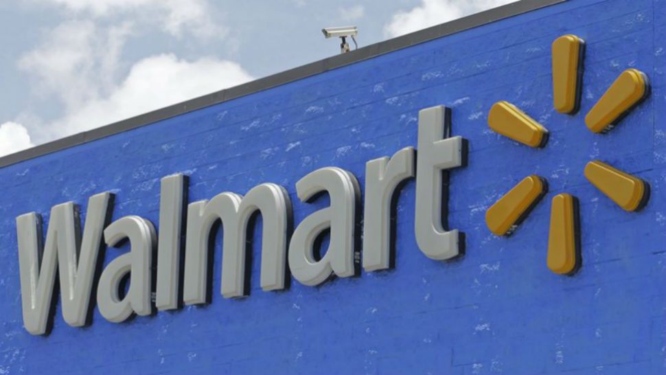 FILE - This June 1, 2017, file photo, shows a Walmart sign at a store in Hialeah Gardens, Fla. Walmart is expanding its same-day online grocery delivery service to more than 40 percent of U.S. households, or 100 metro areas, by year-end as it tries to keep pace with online leader Amazon.com. (AP Photo/Alan Diaz, File)
