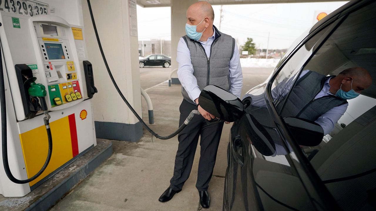 A man dispenses fuel into his vehicle in this file image. (Associated Press)