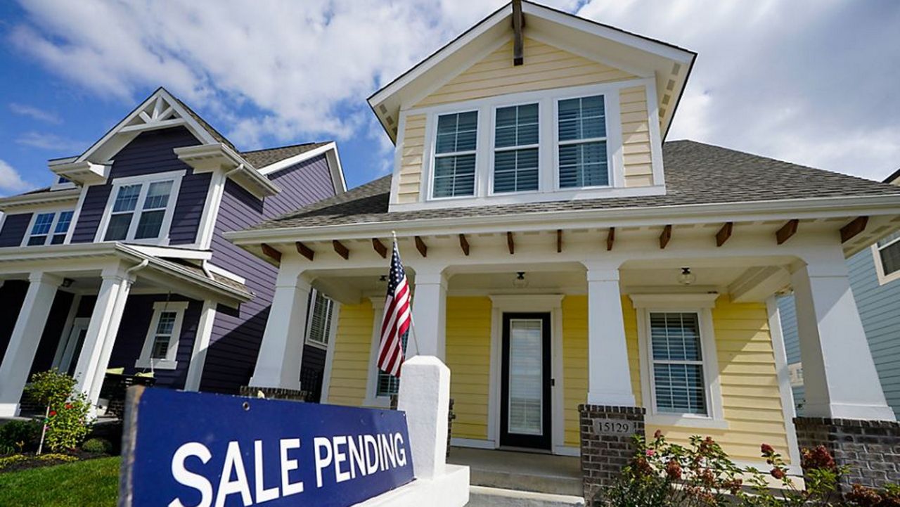 A real estate sign is posted in front of a newly constructed single family home, Thursday, June 24, 2021 in Auburn, N.H.  U.S. home prices soared in April at the fastest pace since 2005 as Americans bid up prices on a limited supply of available properties.    (AP Photo/Charles Krupa)