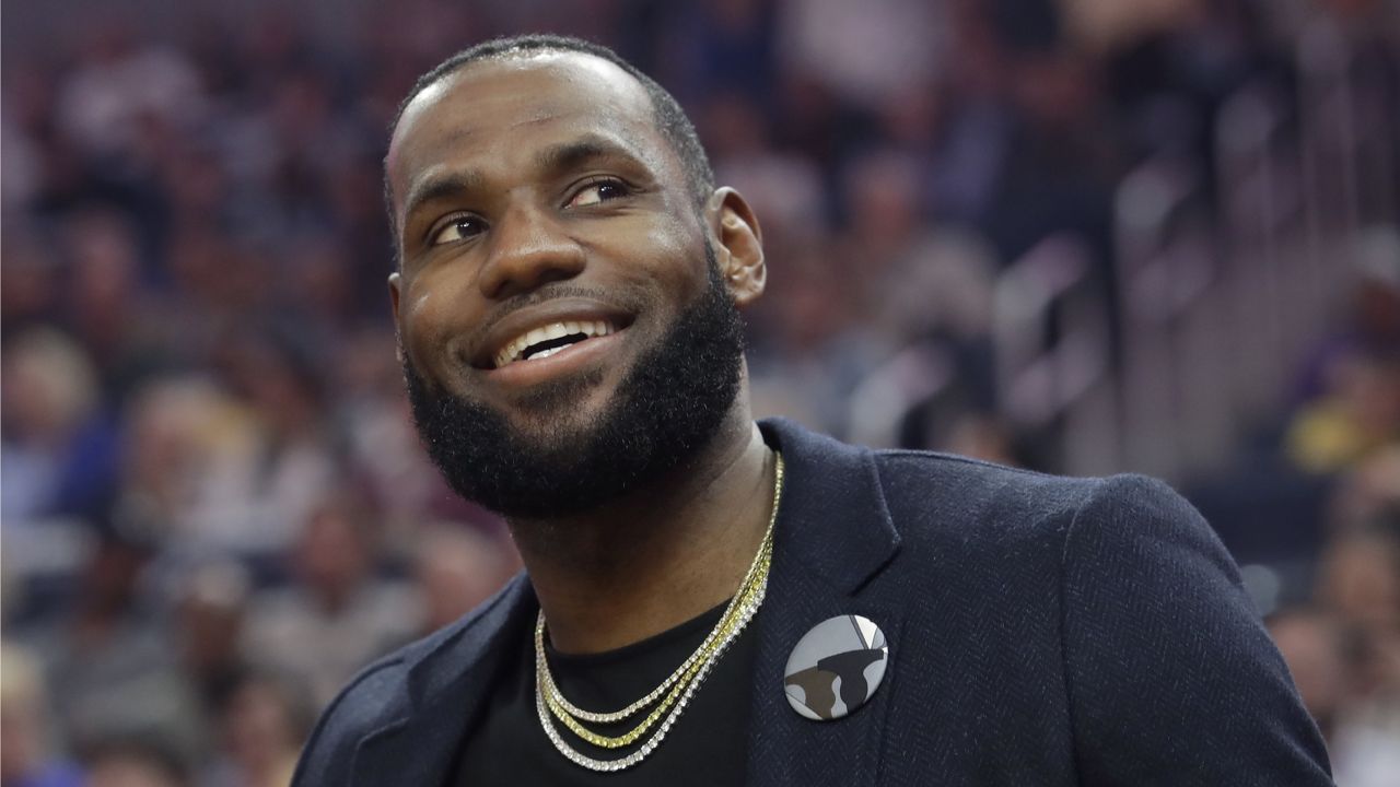 Los Angeles Lakers forward LeBron James smiles from the bench during the first half of an NBA basketball game between the Golden State Warriors and the Lakers in San Francisco, Thursday, Feb. 27, 2020. (AP Photo/Jeff Chiu)