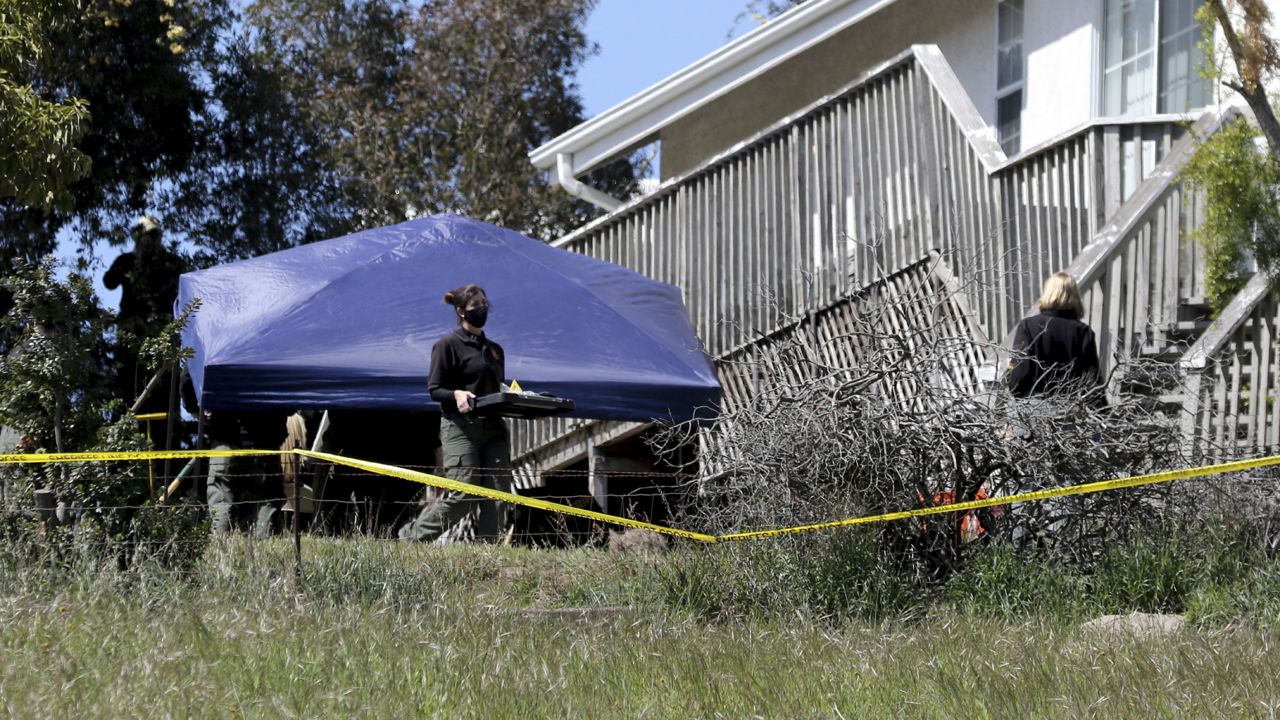 San Luis Obispo Sheriff's Office personnel continue their investigation while searching in the backyard of the home of Ruben Flores, Tuesday, March 16, 2021, in Arroyo Grande, Calif. (AP Photo/Daniel Dreifuss)