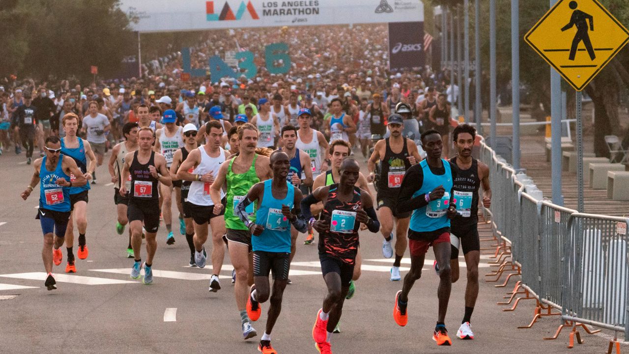 Elite men runners start the Los Angeles Marathon from Dodger Stadium in Los Angeles, Sunday, Nov. 7, 2021. (AP Photo/Damian Dovarganes)