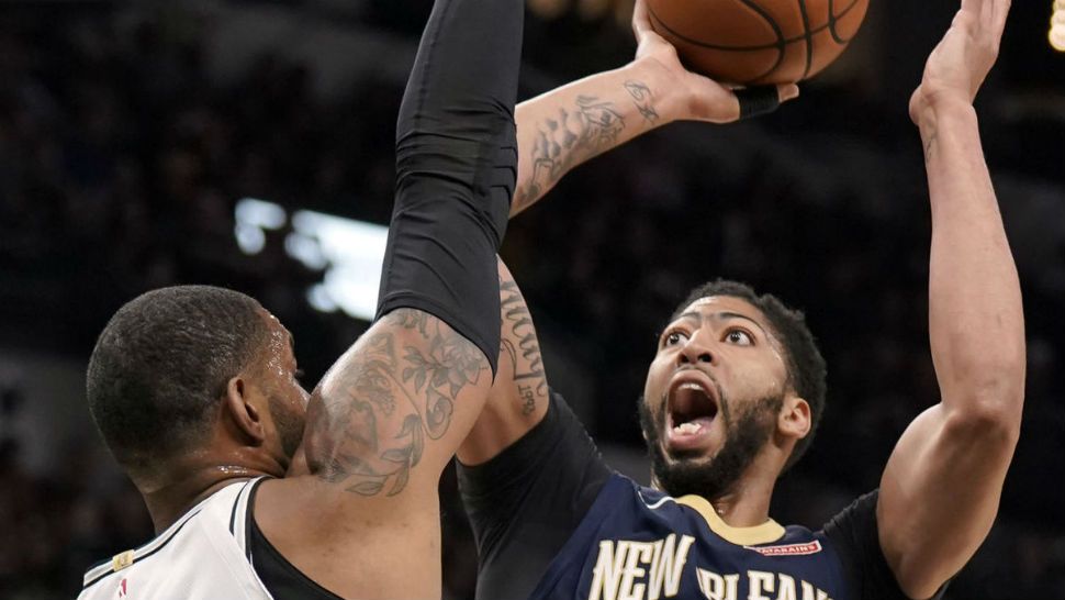 New Orleans Pelicans' Anthony Davis (23) shoots against San Antonio Spurs' LaMarcus Aldridge during the first half of an NBA basketball game, Thursday, march 15, 2018 in San Antonio (AP Photo/Darren Abate)