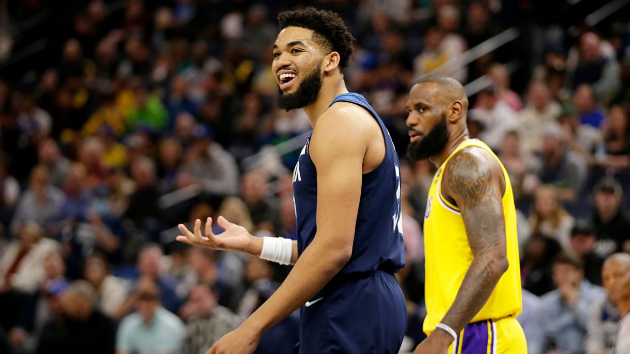 Minnesota Timberwolves center Karl-Anthony Towns argues after being called for charging as Los Angeles Lakers forward LeBron James, right, defended during the first half of an NBA basketball game Wednesday, March 16, 2022, in Minneapolis. (AP Photo/Andy Clayton-King)