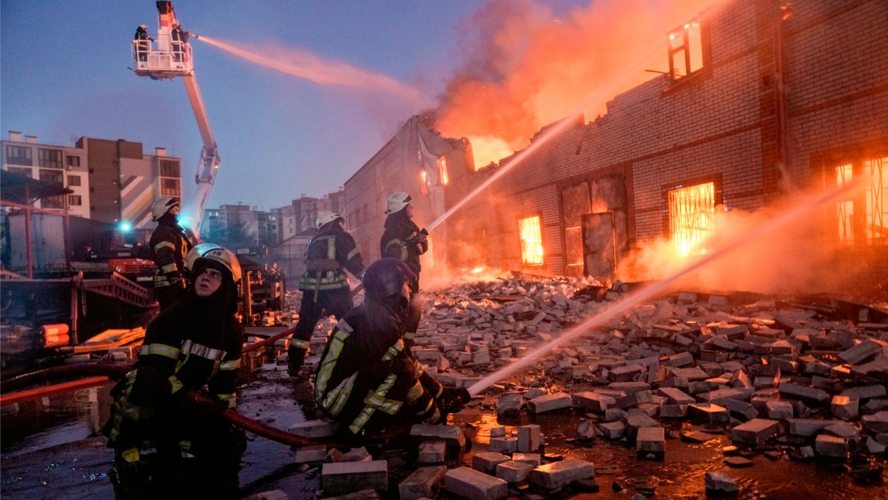 Ukrainian firefighters extinguish a fire at a warehouse after a bombing in Kyiv, Ukraine, Thursday, March 17, 2022. (AP Photo/Vadim Ghirda)