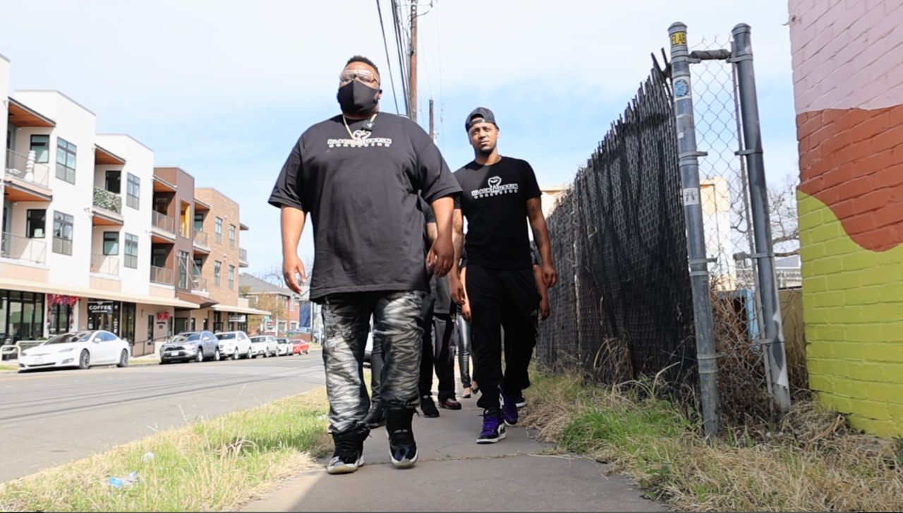Members of the Austin Black Coalition walk through an East Austin neighborhood. (Spectrum News 1/Lakisha Lemons)