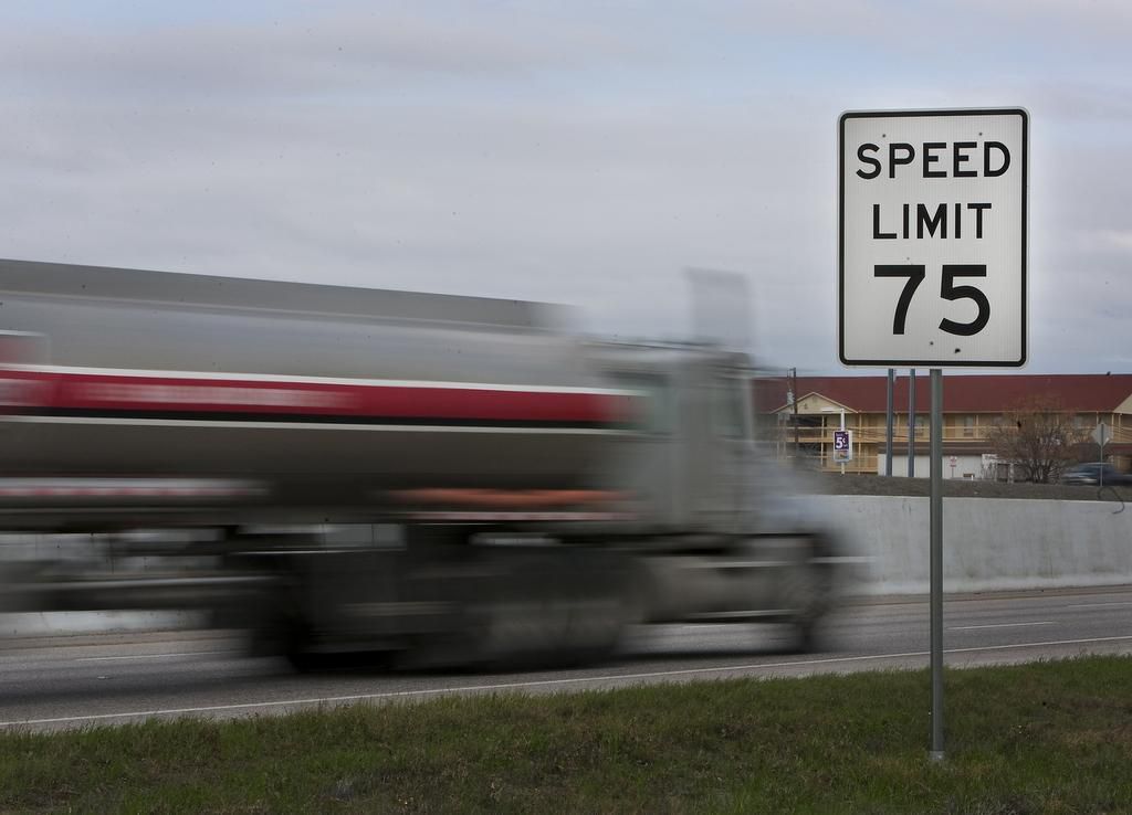 Speed limit sign with car speeding by. 