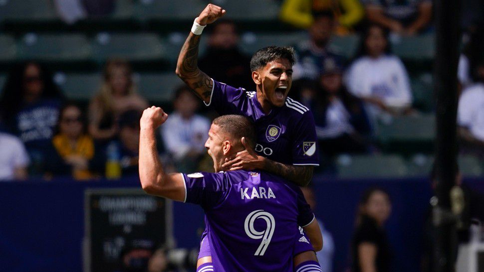 Orlando City forward Facundo Torres, top, celebrates with forward Ercan Kara (9) after Torres scored during the first half of an MLS soccer match against the Los Angeles Galaxy in Los Angeles, Saturday, March 19, 2022. (AP Photo/Ashley Landis)