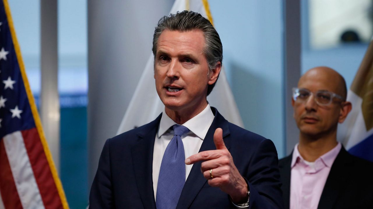 California Gov. Gavin Newsom updates the state's response to the coronavirus, at the Governor's Office of Emergency Services in Rancho Cordova Calif., Tuesday, March 17, 2020. At right is California Health and Human Services Agency Director Dr. Mark Ghaly. (AP Photo/Rich Pedroncelli, Pool)