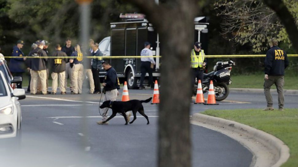 Officials work and stage near the site of Sunday’s explosion, Monday, March 19, 2018, in Austin, Texas. Police warned nearby residents to remain indoors overnight as investigators looked for possible links to other deadly package bombings elsewhere in the city this month. (AP Photo/Eric Gay)