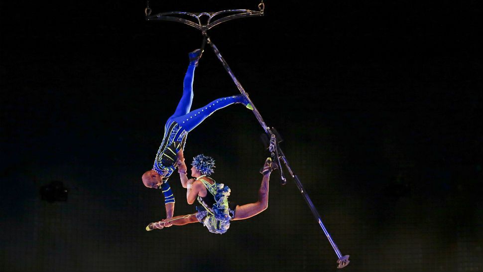 In this April 18, 2016 photo, aerial artists perform in a new act at the Cirque du Soleil show at Disney Springs, in Lake Buena Vista, Fla. (AP Photo/John Raoux)